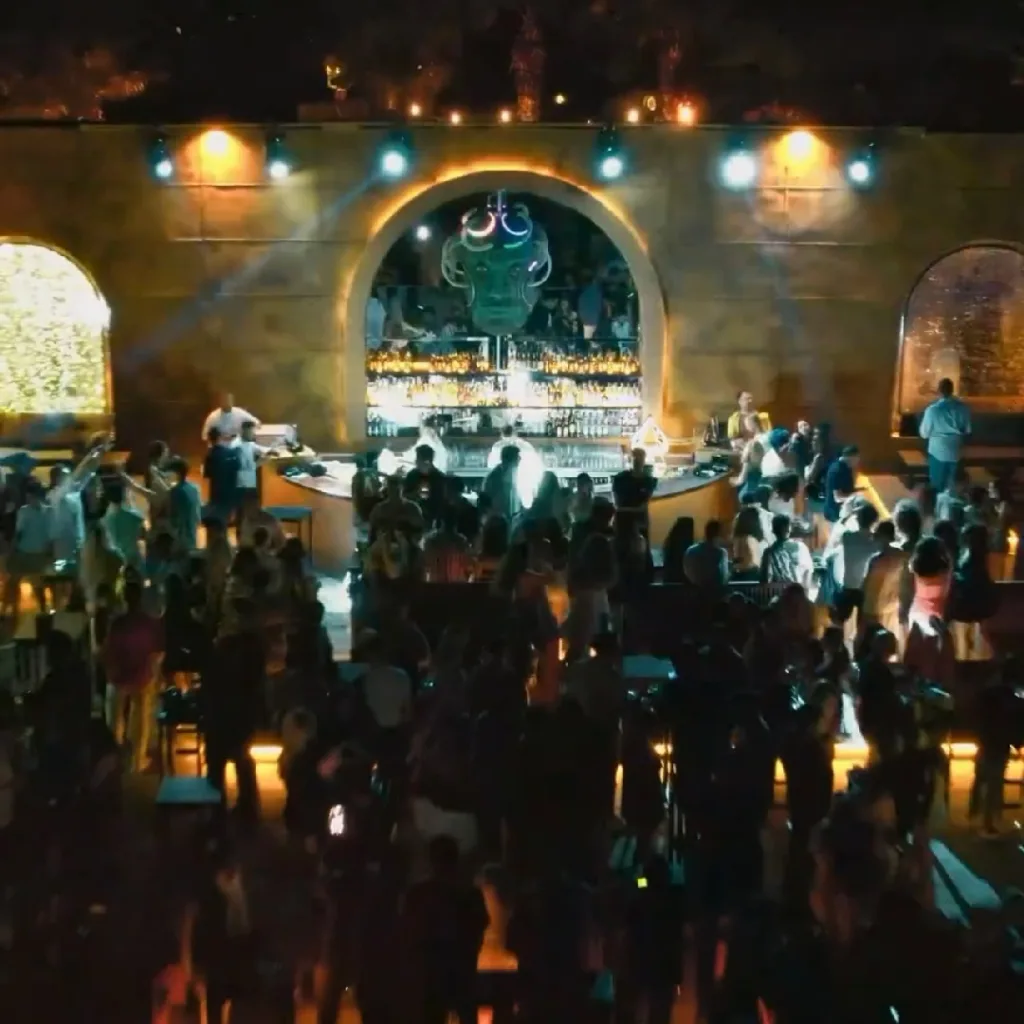 Alaçatı gece klüpleri arasından Flawless Alaçatı'nın maske görünümlü dekorasyonu ve kalabalıkta dans eden insanlar