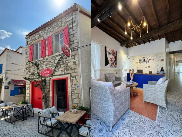 A boutique hotel is shown on the photo. With a red door and build out of stone.